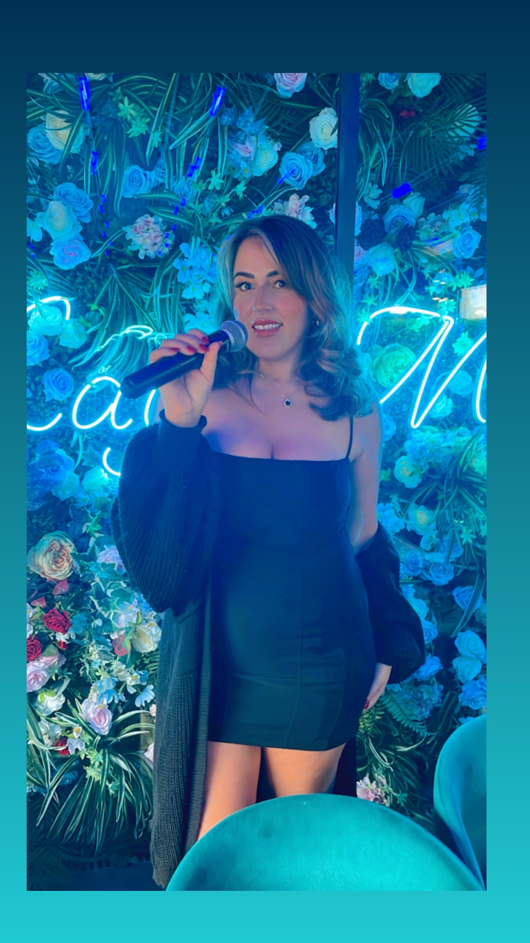 Emma Bennett performing at a blue-lit venue